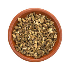 Dried cut and sifted burdock root in a small bowl top view isolated on a white background.