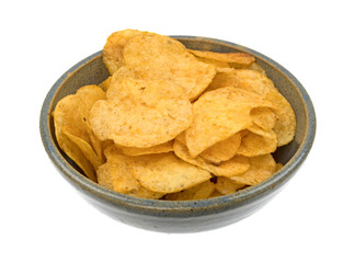 Beef barbecue flavor potato chips in an old bowl side view isolated on a white background.