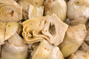 Close view of marinated artichoke hearts.