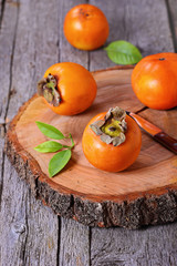 Fresh persimmon on a wooden background