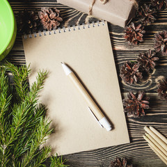 notebook in the center of cute Christmas decoration, cones, fir