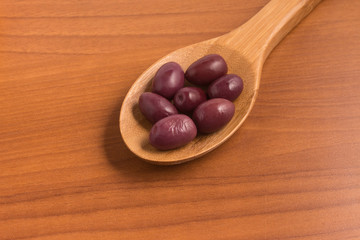 Black olives into a spoon
