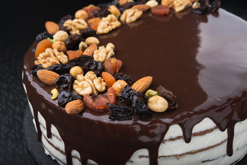tasty chocolate cake with prunes, almond and nuts