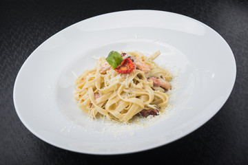 italian pasta with pieces of meat, tomato and cheese