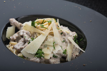 italian pasta with pieces of meat, tomato and cheese