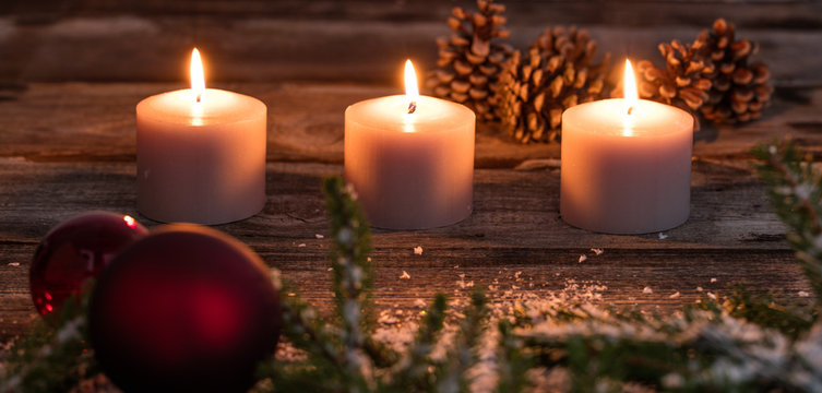 Christmas winter candlelight with candles and tree bulb on wood