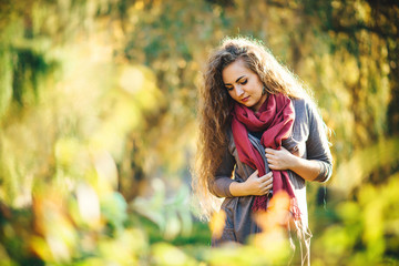 Young beautiful woman at the autumn park.