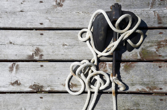 Dockside Anchor And Line Laying On A Pier