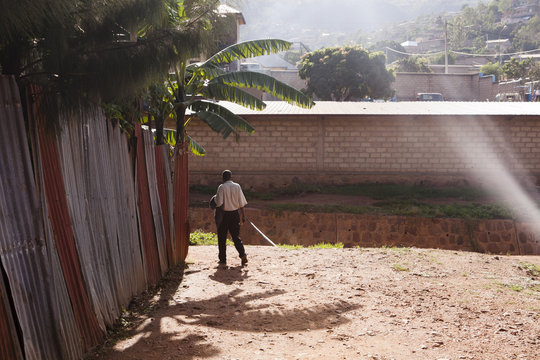 A man walking in the slums of Kigali.