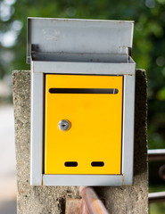 Yellow mailbox in front of the house