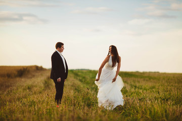 happy and young bride and groom having fun together