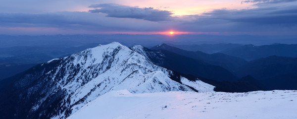 Winter panorama of mountains at sunset