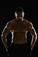 Fototapeta na wymiar very muscular man posing with naked torso in studio
