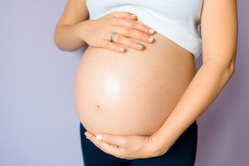 Pregnant asian woman holding the belly