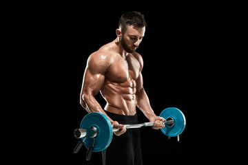 muscular man lifting weights over dark background