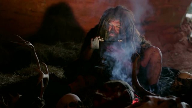 Prehistoric caveman using tablet PC