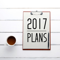 2017 plans on on clipboard over white wood background