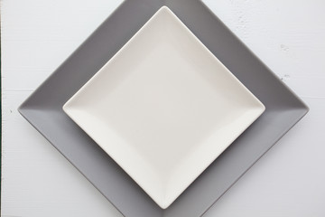 Empty white ceramic dish on over white  wooden table