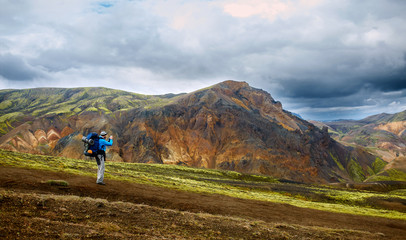 hiker on the trail in the Islandic mountains. Trek in National Park Landmannalaugar, Iceland