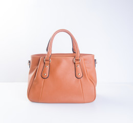 bag or brown leather woman handbag on background.