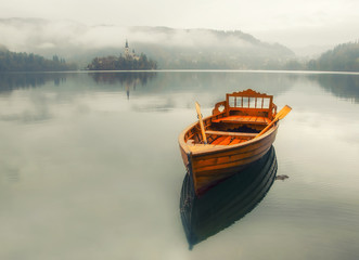Lonely boat on the water surface of Bled lake, Slovenia