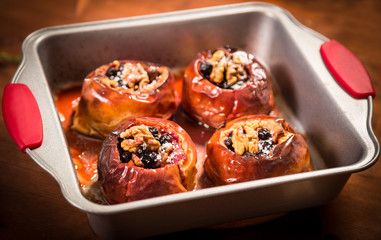 backed apples with nuts and berries in tray