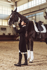 woman jockey with his horse