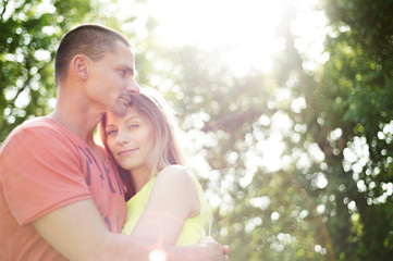 Fototapeta premium Beautiful young couple in love. Sunny summer nature.