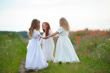 Fototapeta na wymiar Three happy children holding hands and playing