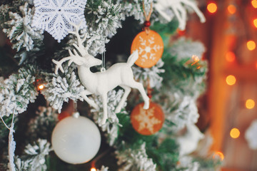 Fototapeta na wymiar Green decorative christmas tree with figure of deer, vintage toned