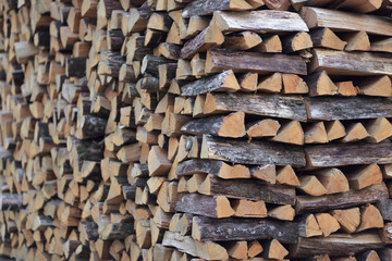 chopped firewood stacked for storage for the winter. background texture