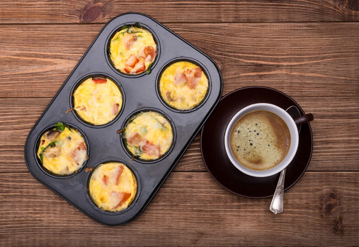 Breakfast Egg Muffins With Ham, Cheese And Vegetables. Cup Of Coffe.