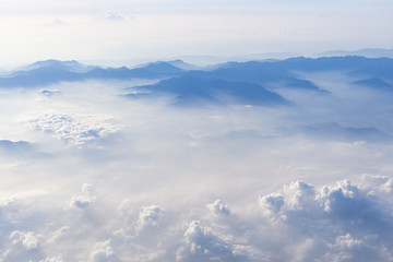 Blue sky and mountains view from airplane stylized hipster background with copyspace