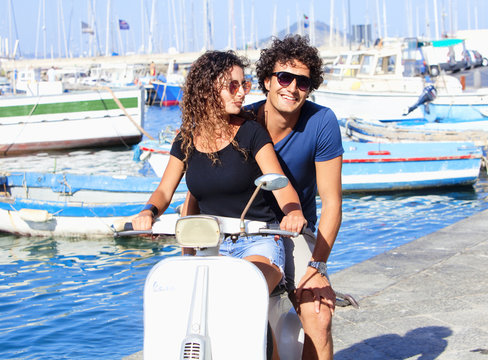 Young Italian Couple On Vespa Scooter Having Fun