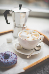 Warm cozy home. Tray and cup of coffee with marshmallows 
