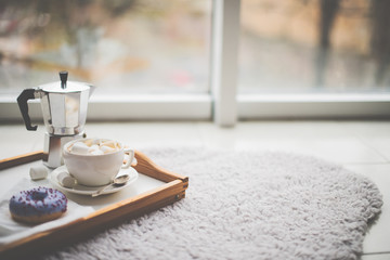 Warm cozy home. Tray and cup of coffee with marshmallows 