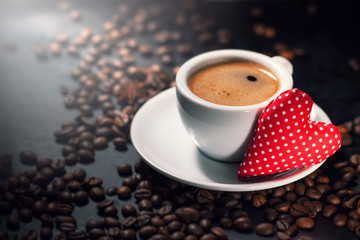 Coffee espresso with coffee beans on a background and red plush