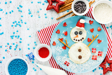 Fototapeta na wymiar Funny snowman pancake for breakfast - Christmas and New Year fun food idea