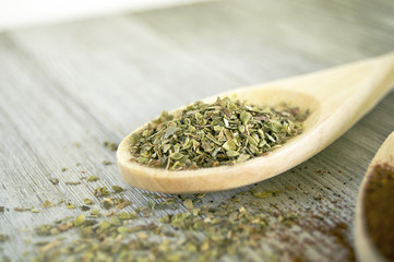 Oregano on wood spoon