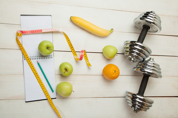 diet plan, menu or program, weight loss, measuring tape, dumbbells and dietary food fresh fruit - 127093722