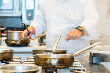 chef preparing food in a restaurant kitchen
