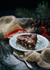 Traditional homemade christmas cake holiday dessert with cranberry in new year tree decorations frame on vintage wooden table background. Rustic style