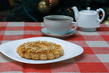 Homemade cookies in a plate on the feast of the new year, christmas. Tasty cookies on a table with a Christmas tree in the background. Tea.