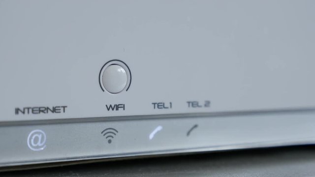 On white Internet router Wi-Fi signal turning OFF 4K 2160p 30fps UltraHD footage - Finger pressing wireless device button 3840X2160 UHD video 