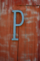 Letter P on Red Barn Wood Wall