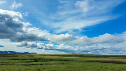 Iceland Landscape with clouds in blue sky and mountains in distance