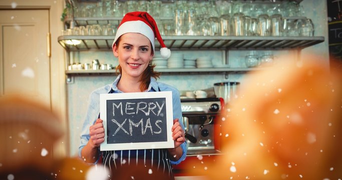 Composite image of portrait of happy barista holding christmas a