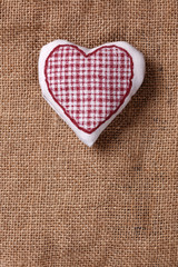 Handmade heart shaped pillow on burlap