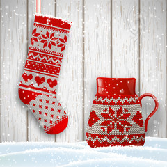 knitted christmas stocking and red tea cup in front of white wooden wall, illustration