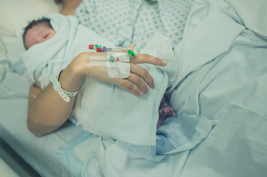 Mother With Newborn Baby In Hospital Bed